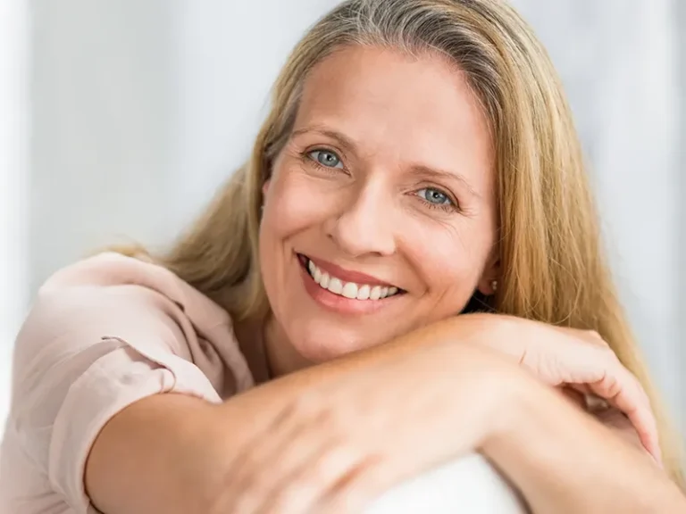 Mature woman smiling confidently after treatment with a cosmetic dentist in Bellingham at Roots Dental.