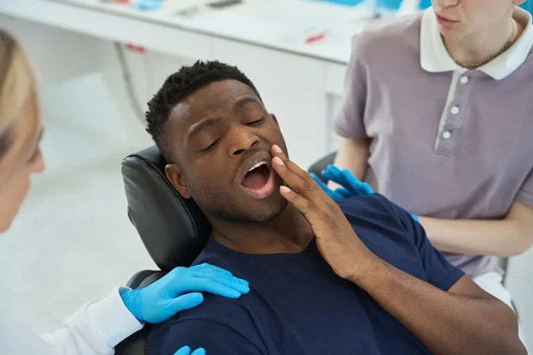 a young man suffering a shooting wisdom tooth pain